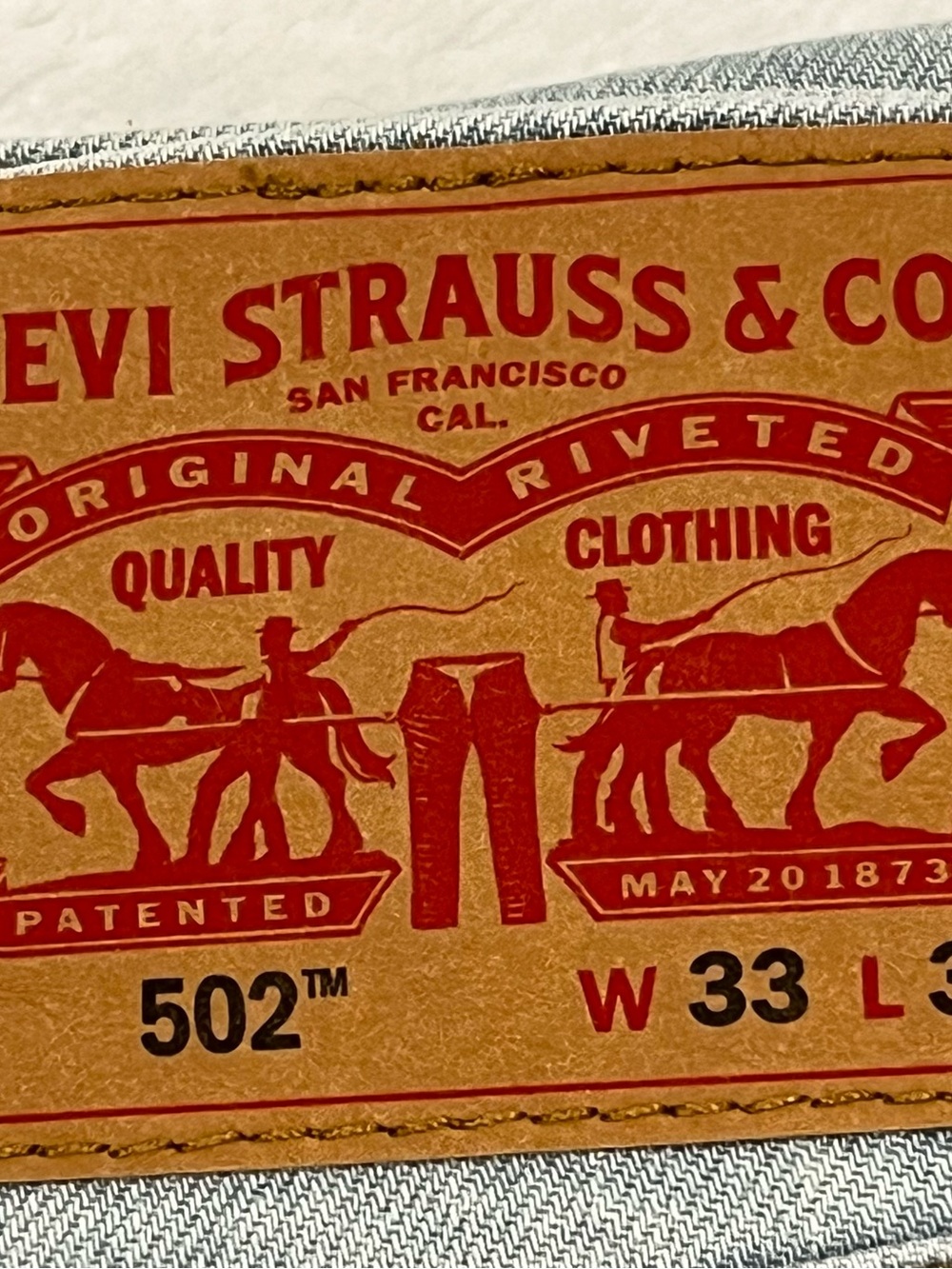 Levi Strauss 502 Regular Tapered Fit Jeans in Blue with Tan Leather Patch
